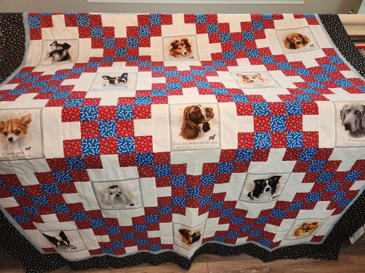 A colorful patchwork quilt with dog images.