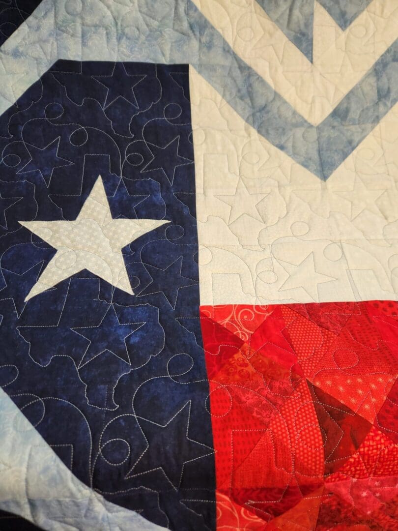 Close-up of a Texas flag with a white star and red, white, and blue sections.