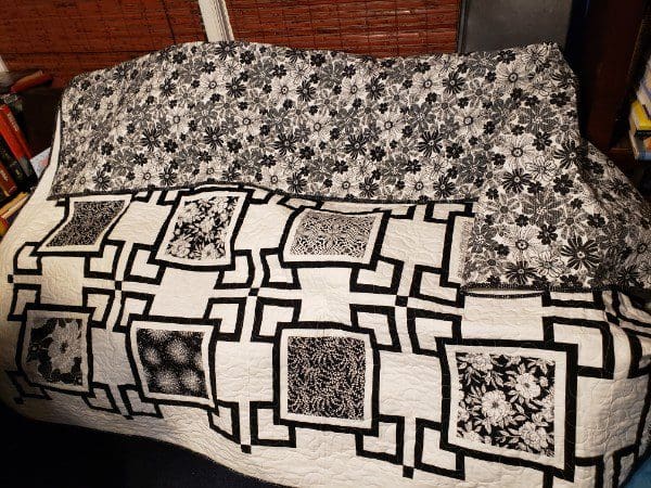 Two patterned blankets with floral and geometric designs.
